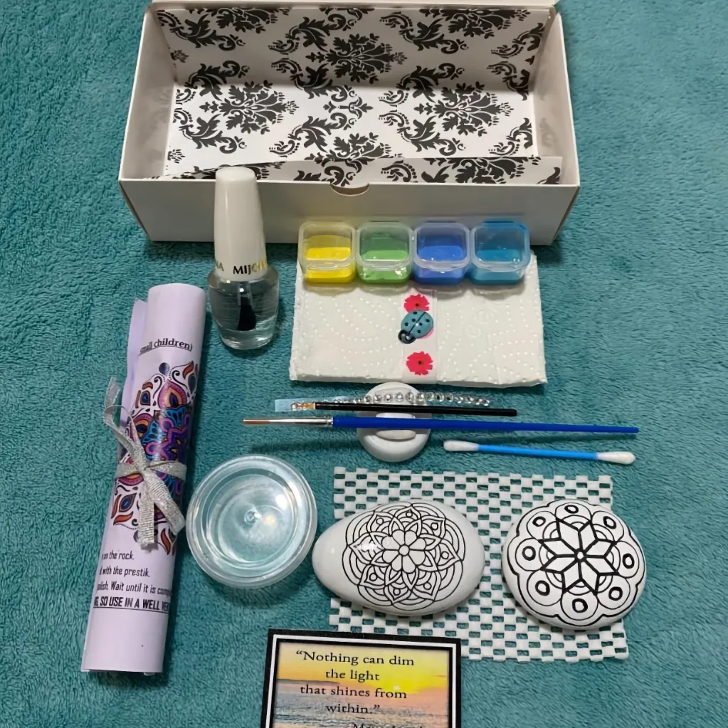 Paint pack unpacked and showing off mandala outlines on pebbles, ready for painting in the next class, for a paint-at-home kit, or private lesson