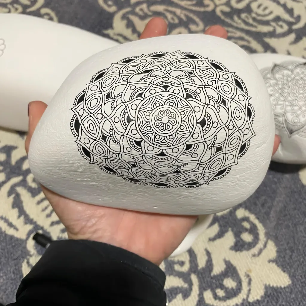 large doorstop stone painted with ornate mandala pattern