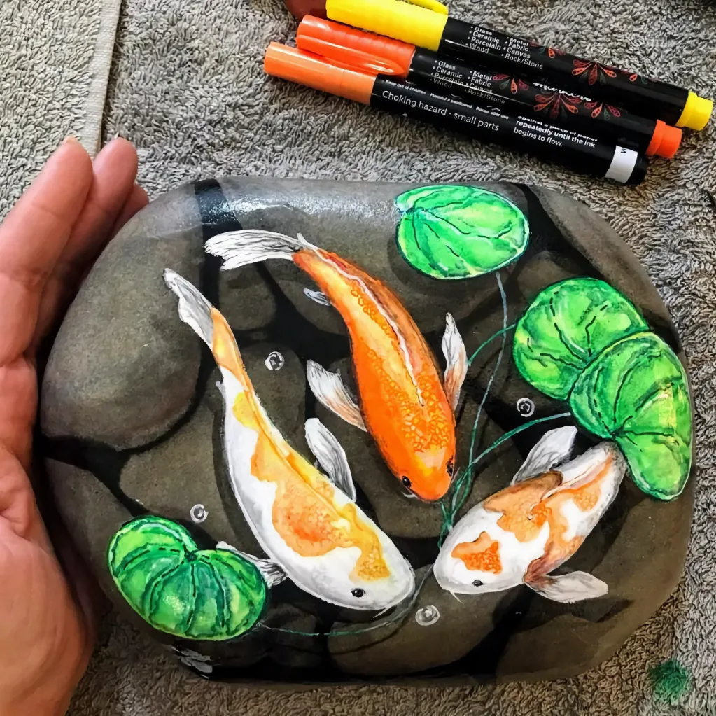 beautiful coy painted stone to be used as a doorstop