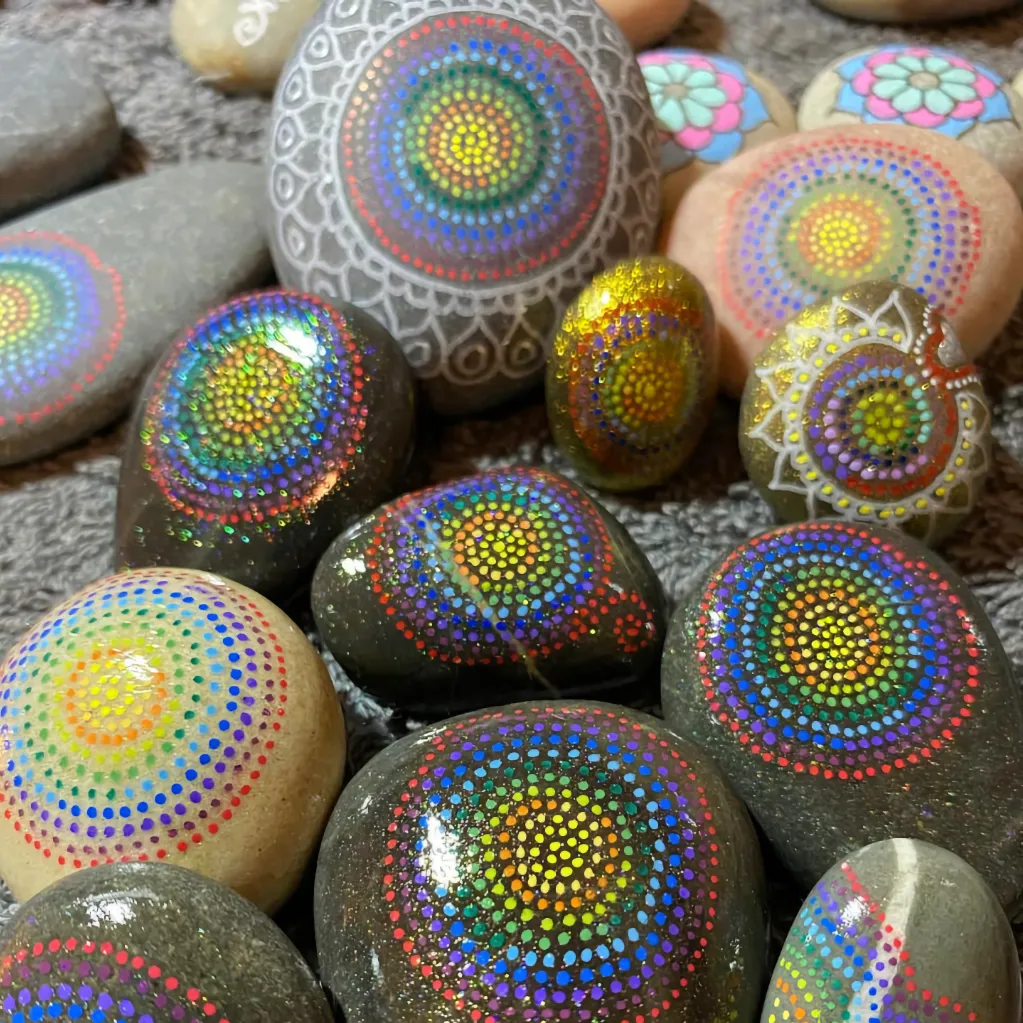group of ornately tribal dot painted stones