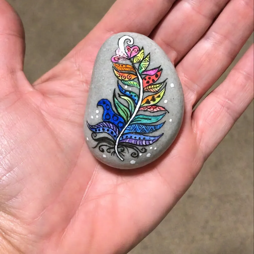 ornate palm leaf multi-coloured and stylised, in the palm of a hand